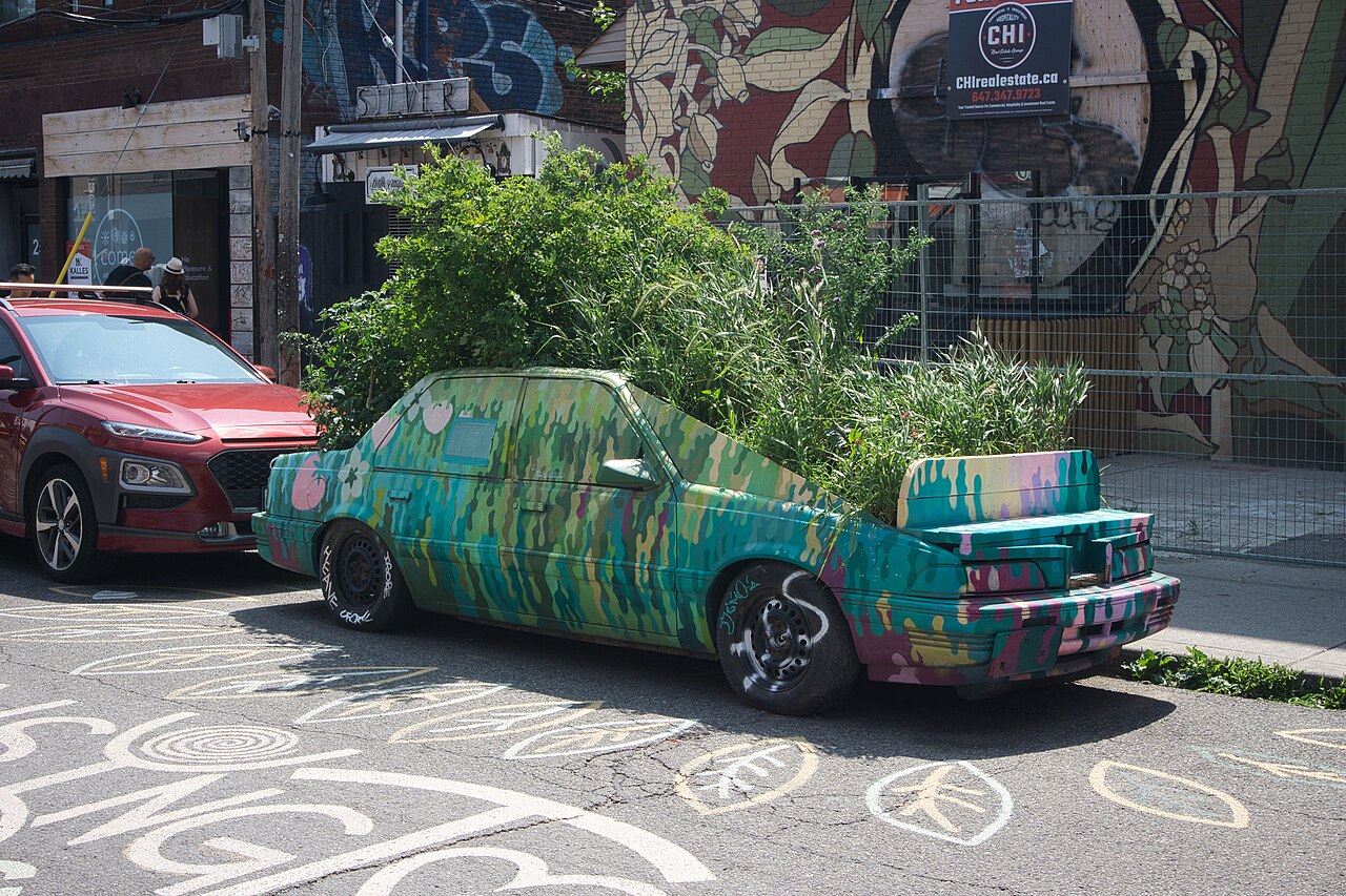 The plant-covered garden car parked in Kensington Market